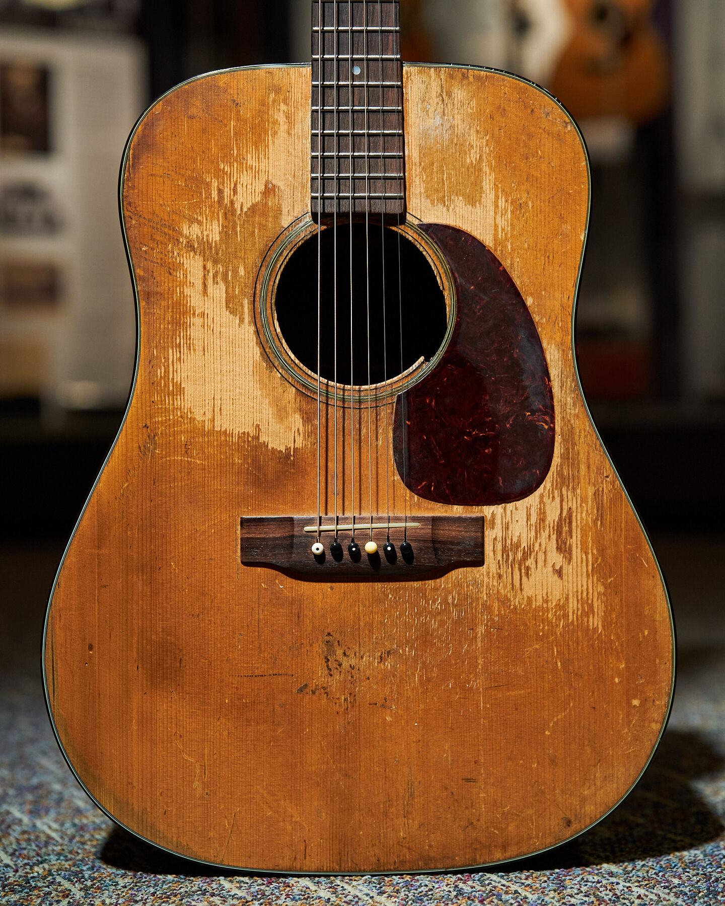 Shot of the body of a well-worn D-18 acoustic guitar